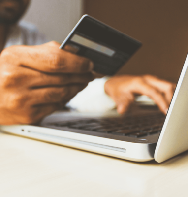 Hands holding a credit card at a laptop, cover for how streaming boosts e-commerce sales