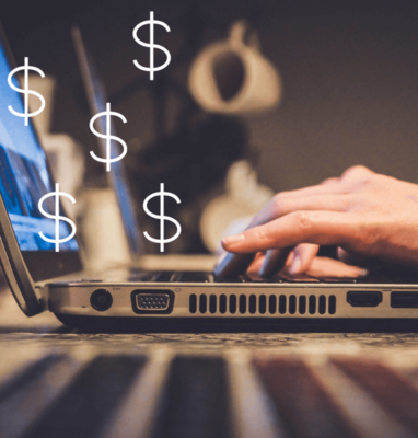 Hands typing on a laptop with dollar signs, illustrating AVOD, SVOD, PVOD and FAST monetization