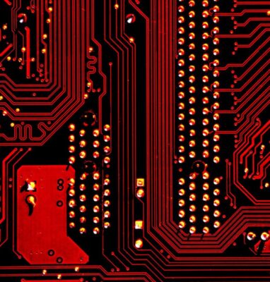 Red circuit board close-up, cover for an article on video codec evolution from MPEG-1 to AV1